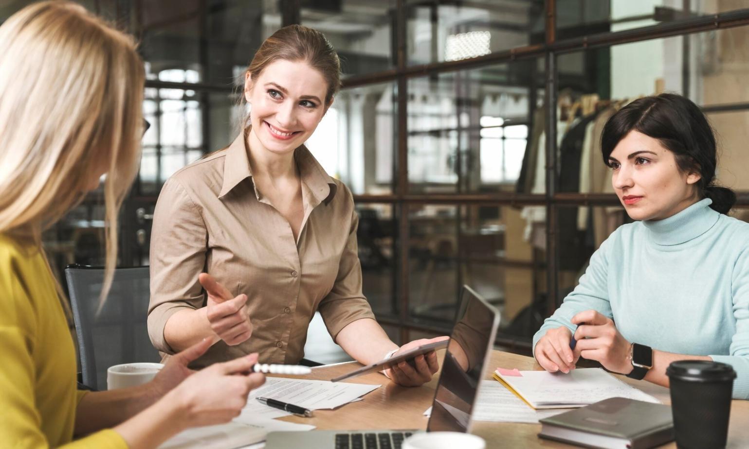 Business mentoring session with mentor and client reviewing financial documents